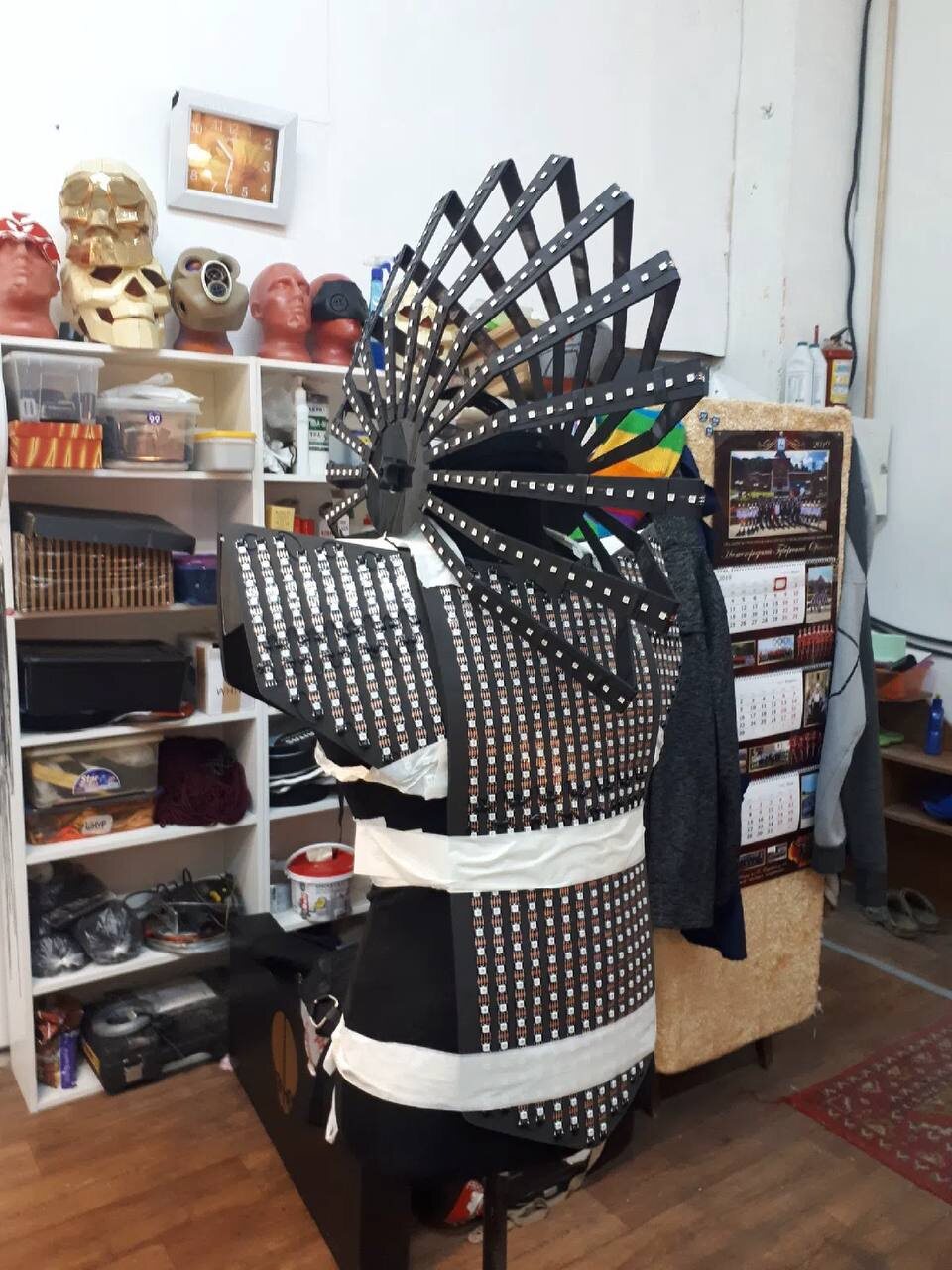 LED costume mid-build on a dress form, hundreds of unlit pixels