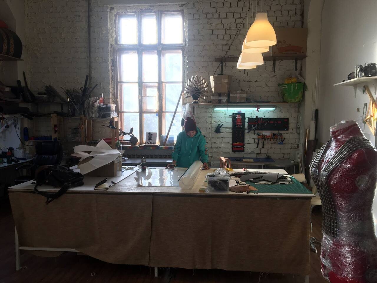 Annie working at a large cutting table in the Peasok Studio loft