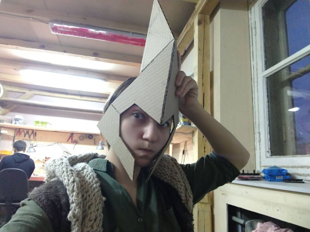 Cardboard mock-up of the helmet, test-fitted in the workshop