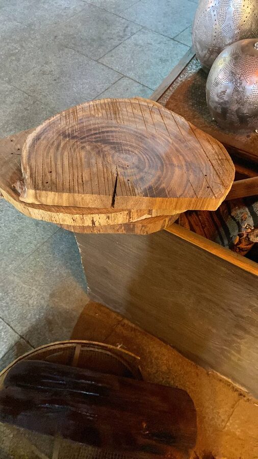 Rough-sawn live-edge slabs stacked on a crate, saw marks and splits